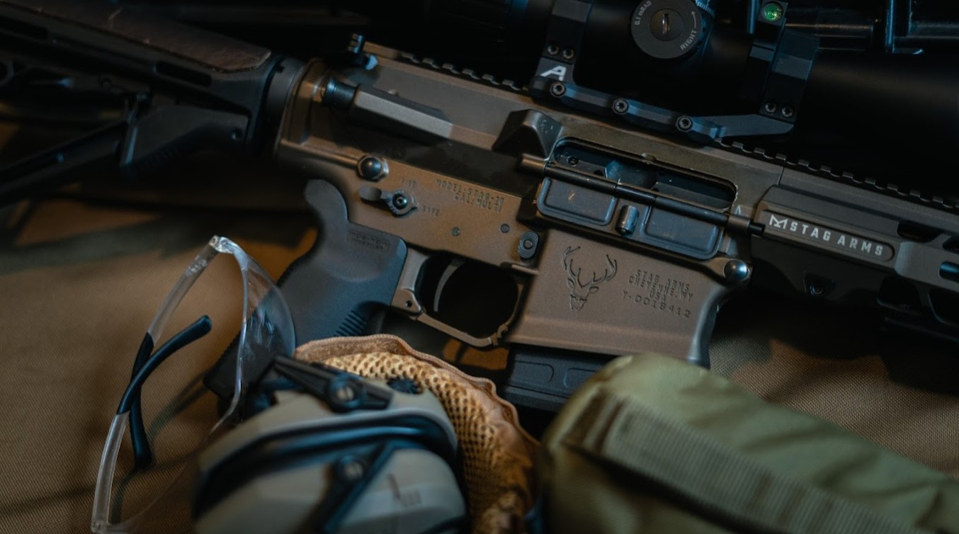 A high-end tactical rifle resting on a wooden table with a blurred shooting range in the background, representing premium outdoor branding.