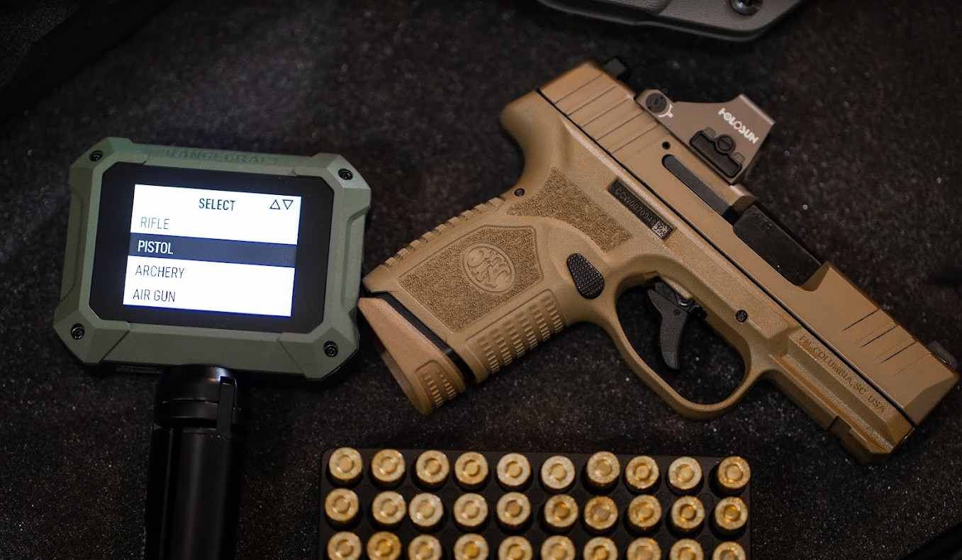 A flatlay of outdoor gear including a pistol with optic, athlon chronograph, and 9mm ammunition